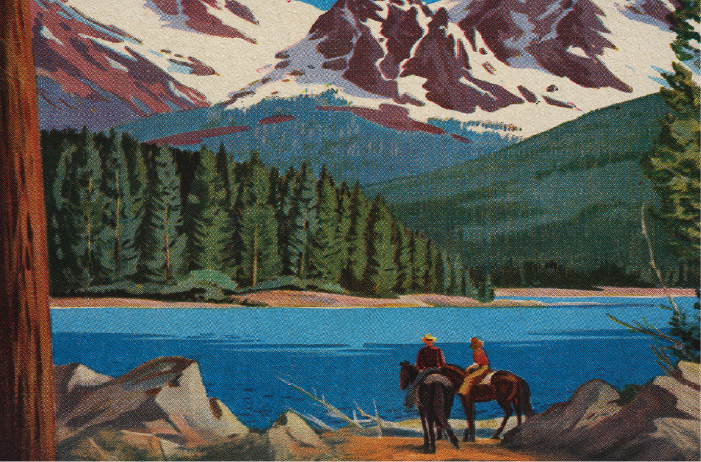 Two horses staring at a lake with mountains in the background